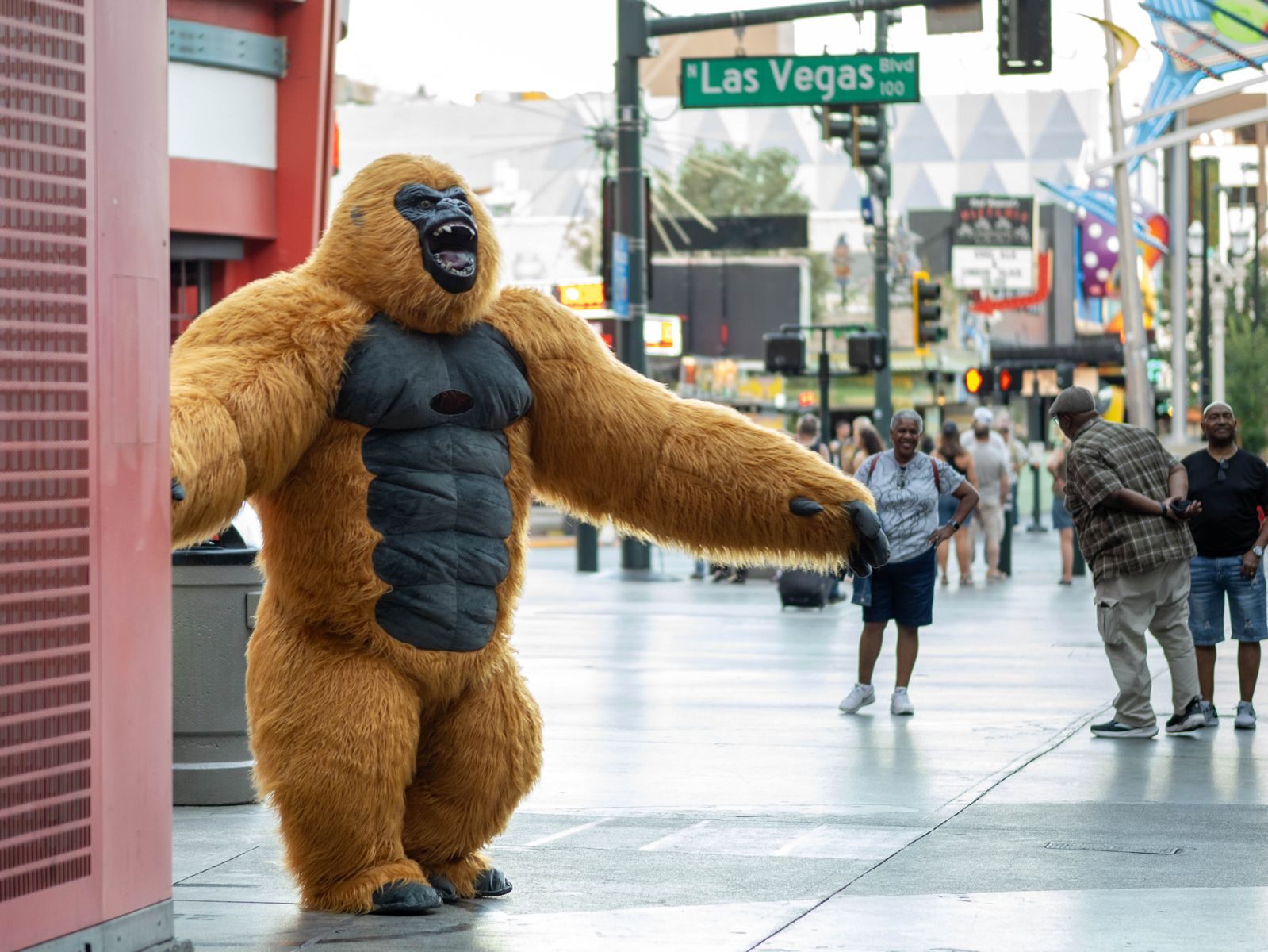 Gorilla costume performer entertaining people on bustling Las Vegas Boulevard.