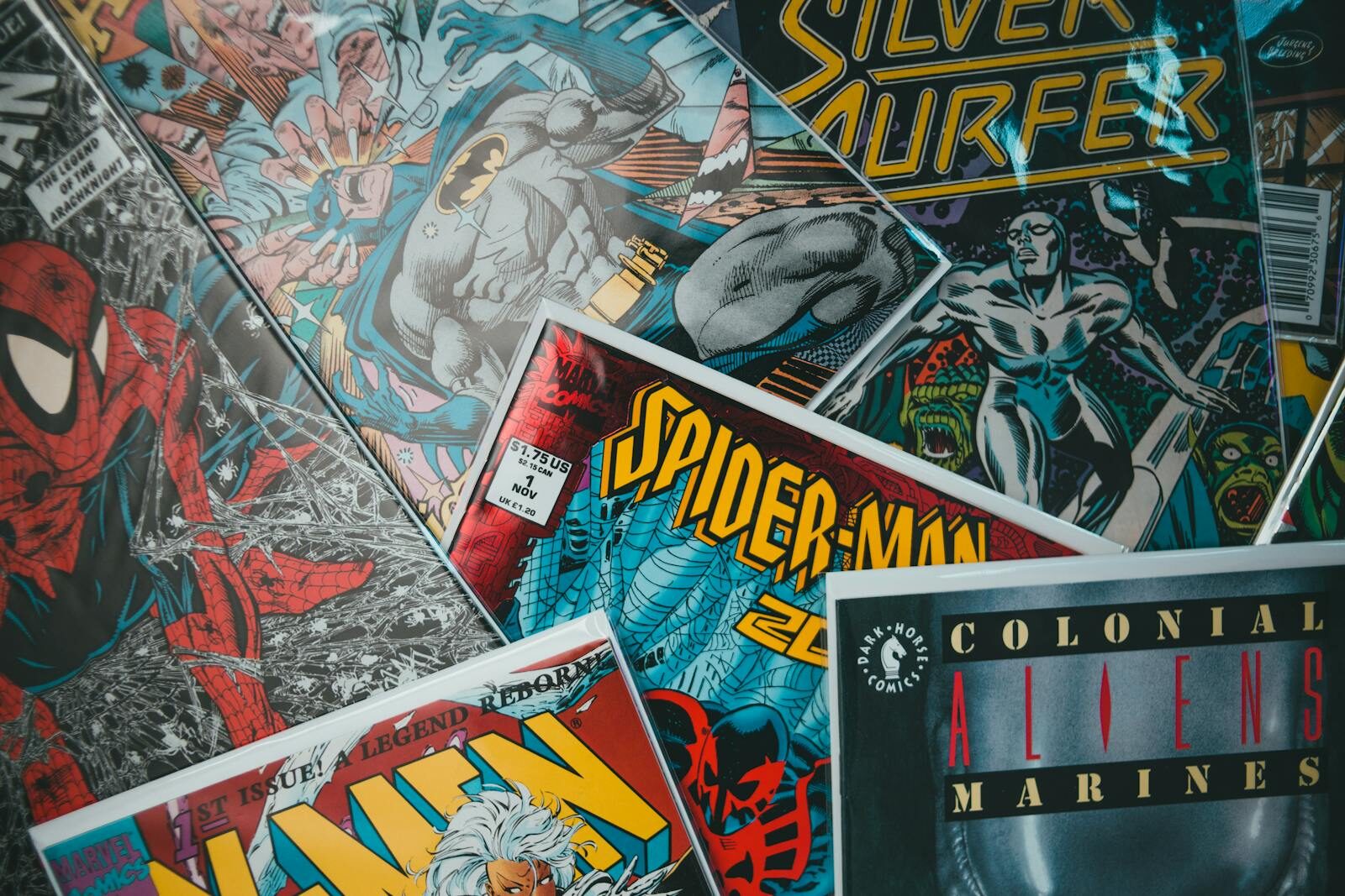 From above closeup of collection of assorted creative comic magazines with colorful illustrations spread out on surface