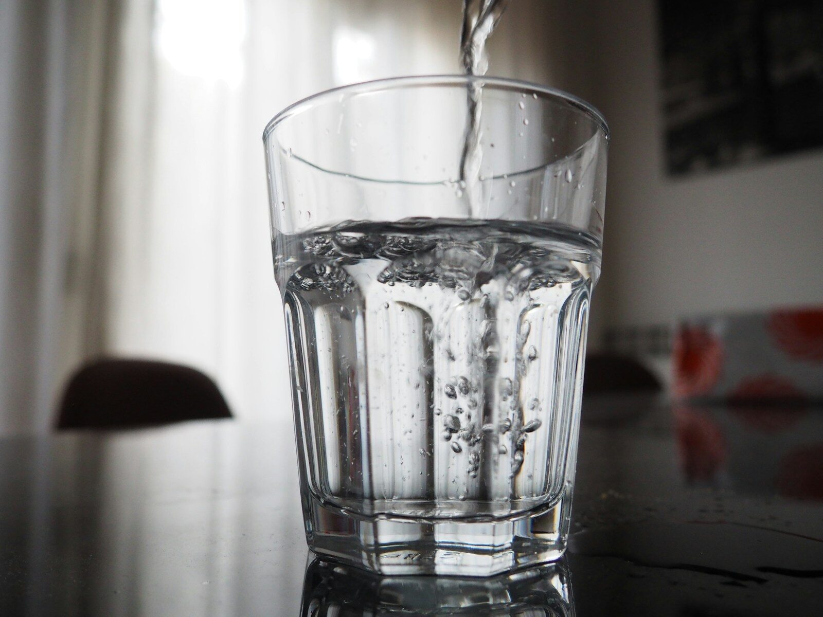 Water is being poured into a glass.