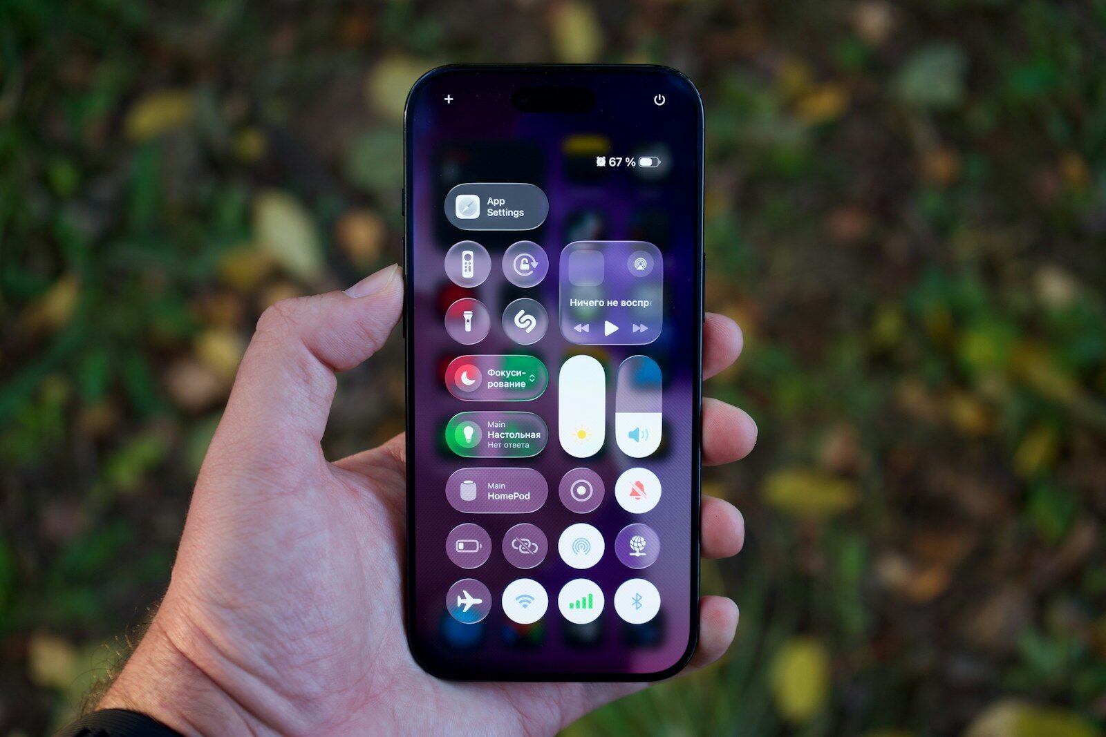 Hand holding a smartphone with colorful app icons.